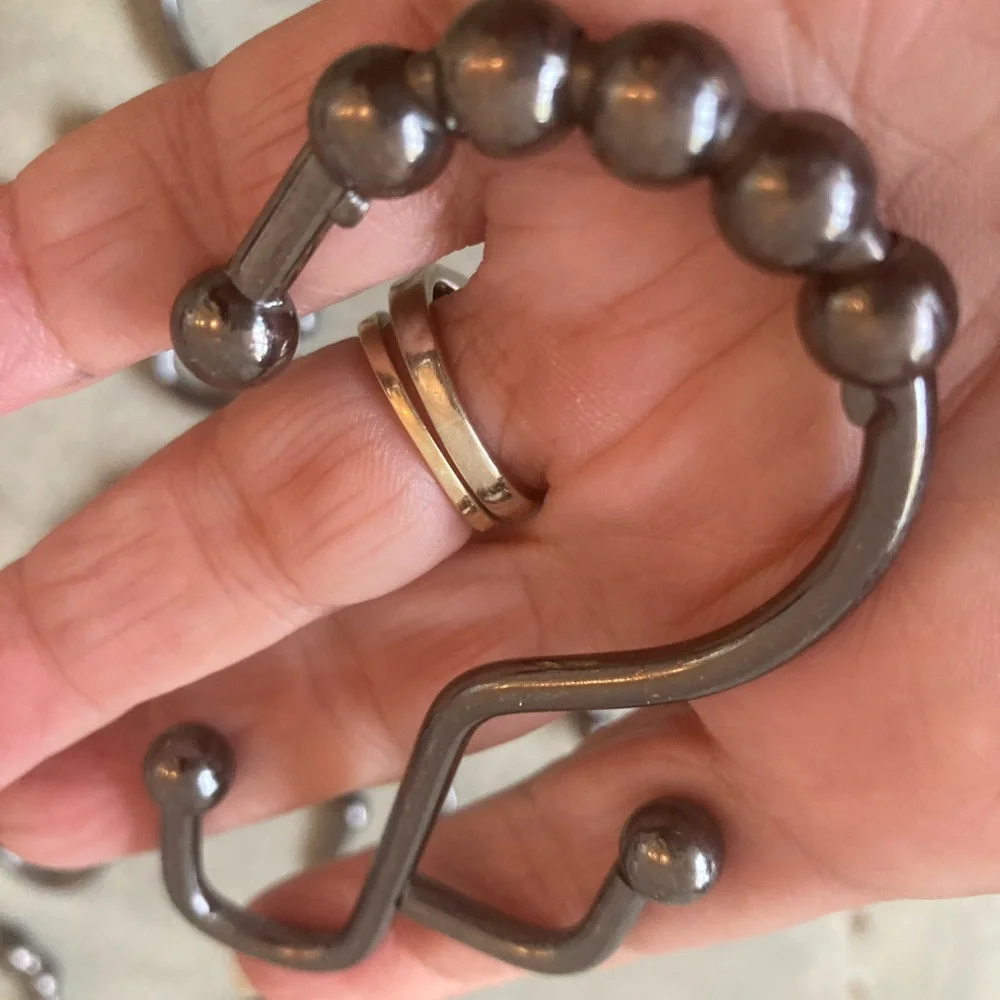 12 industrial style pewter shower curtain hooks. Perfect never used.